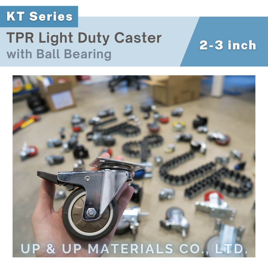 Hand holding chrome plated TPR light duty caster with plate mount, 2-3 inch size, ball bearing design, workshop background.